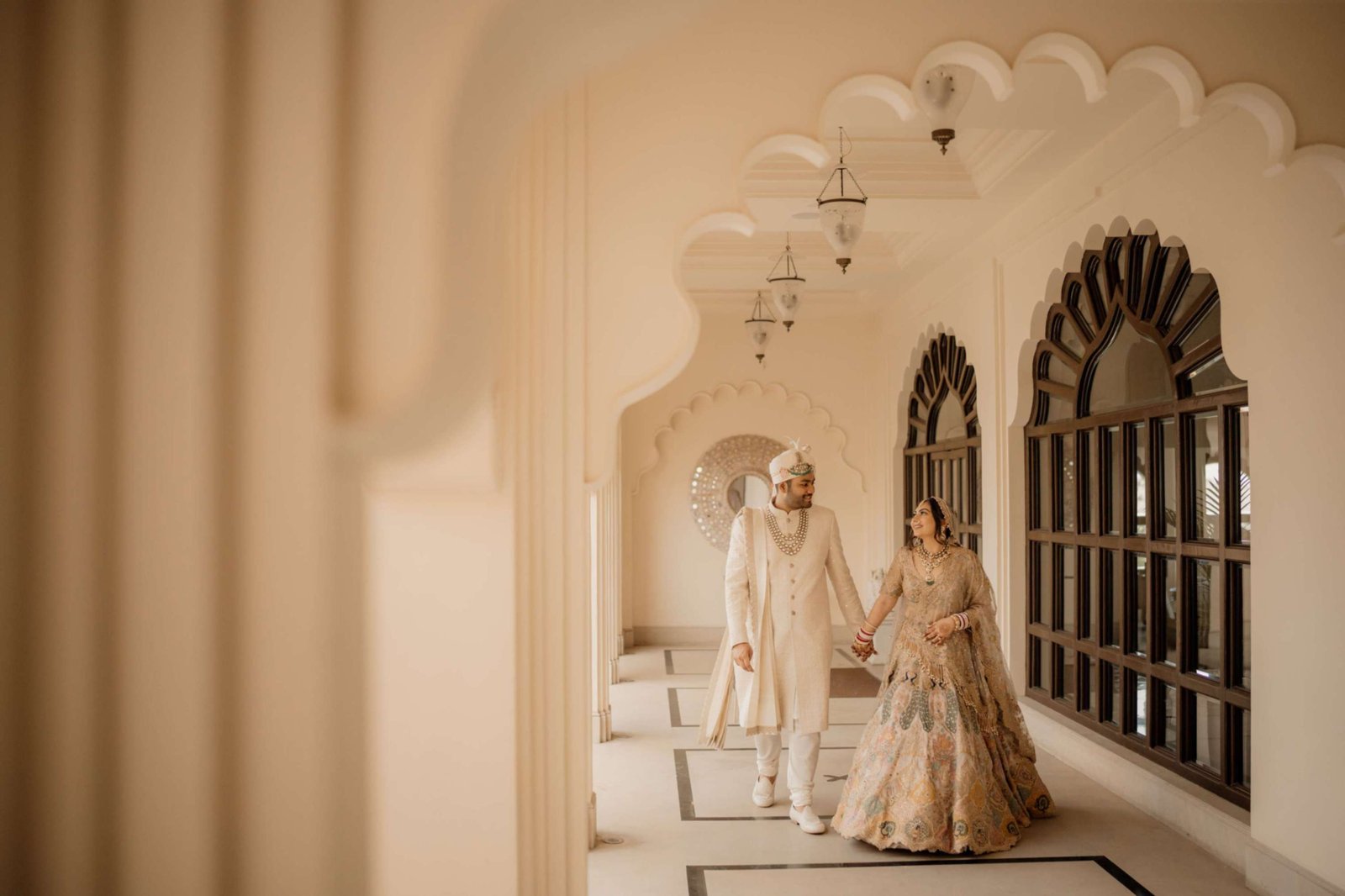 Bride and groom portrait beneath a floral archway — Shaadi Shenanigans