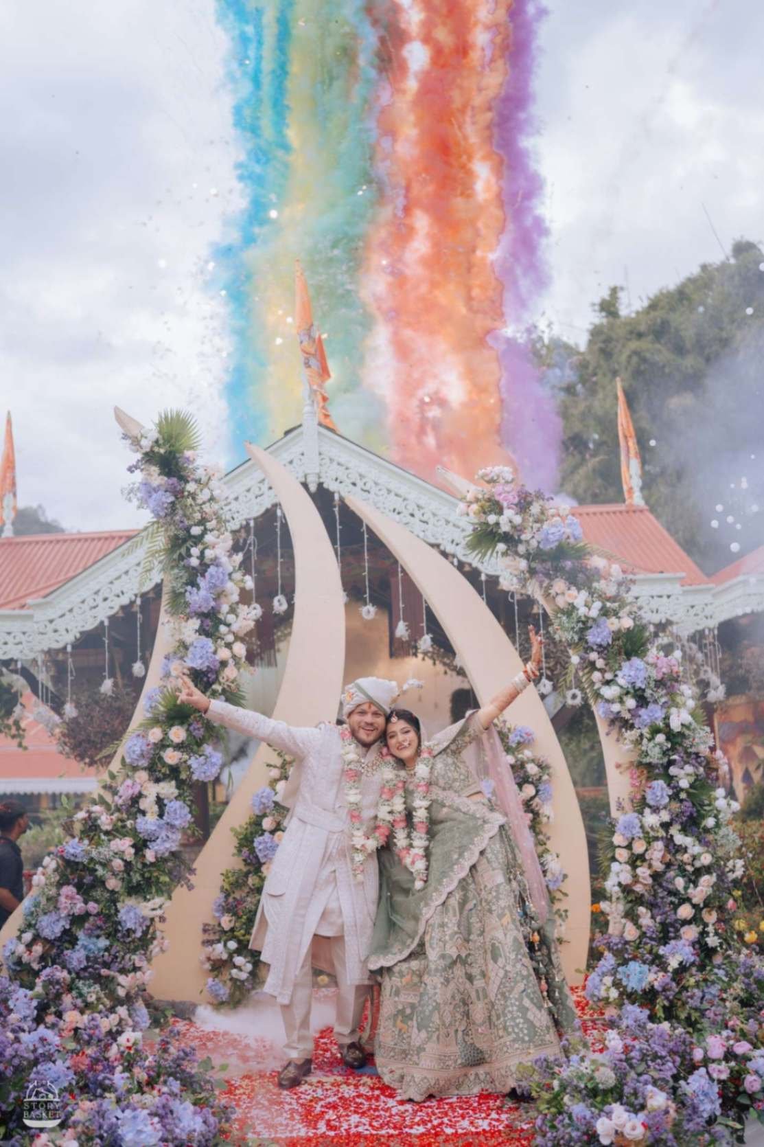 Newlywed couple celebrating under a colourful smoke send-off at a Shaadi Shenanigans wedding